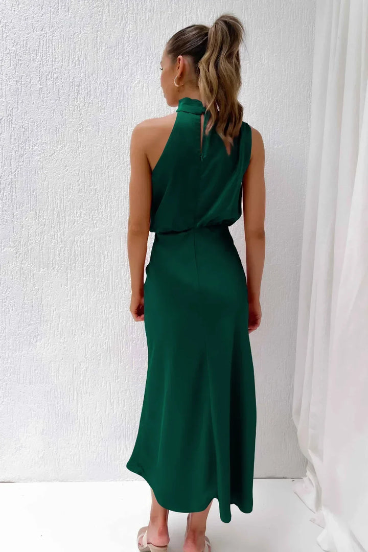 Female posing in a lightweight casual outfit against a plain studio background, back view