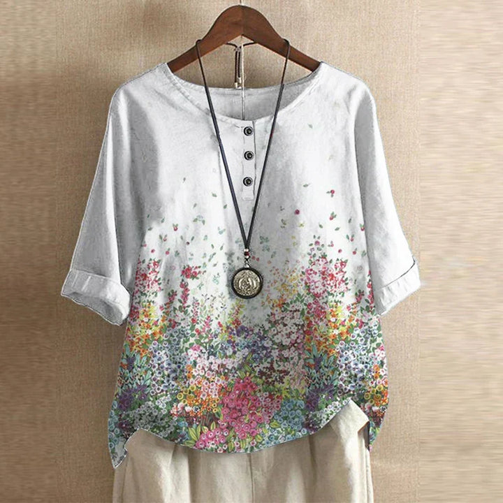 Flowing floral maxi dress against a plain background.