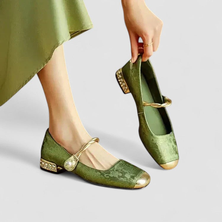 Woman wearing black Mary Jane shoes on a plain background.