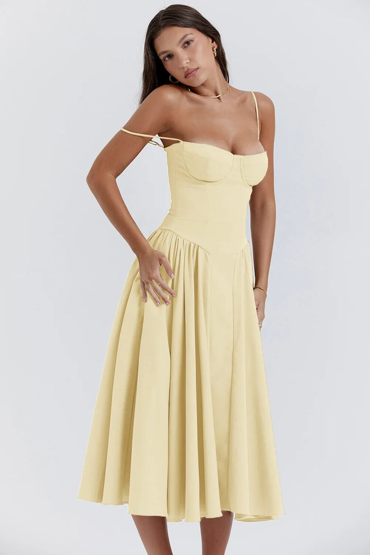 Woman in a lightweight dress with a flowing hem on a plain background.