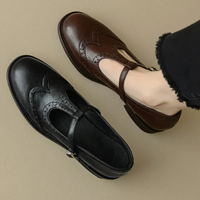 Female model showcasing classic buckle Mary Jane shoes on a plain background.