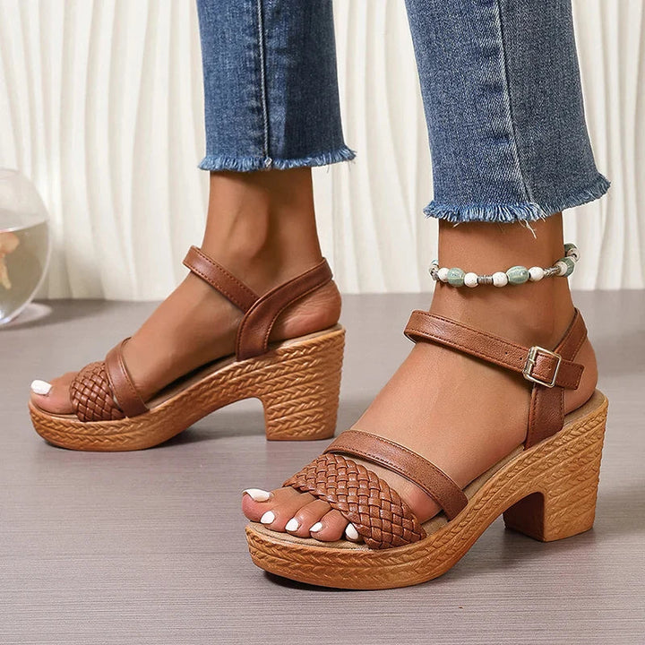  Female model in woven open-toe sandals with a lightweight raised sole.