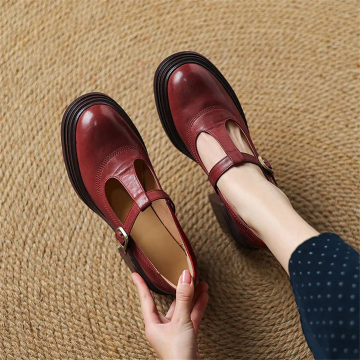 Female wearing chunky block heel Mary Jane shoes on a plain background.