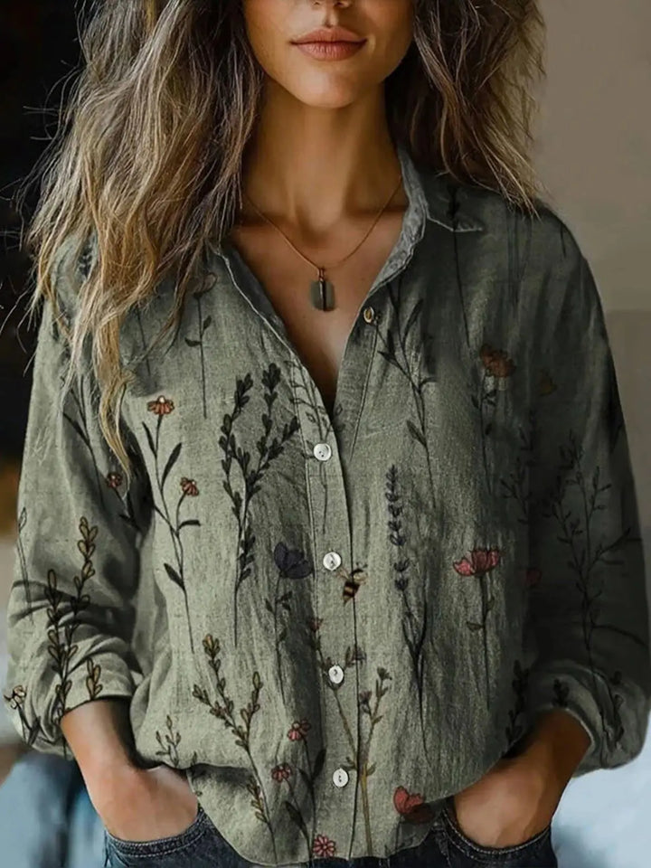Woman modelling a button-down floral shirt with a classic collar.