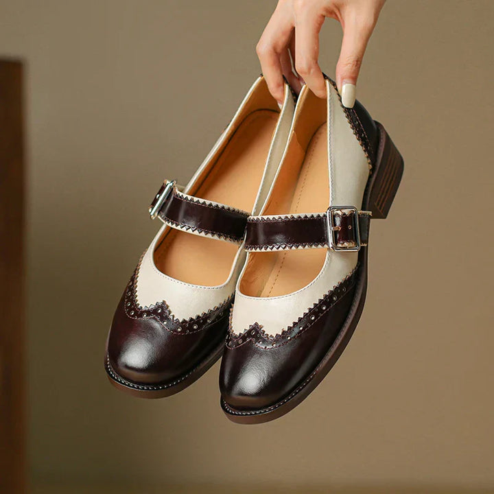 Vintage-style Mary Jane flats on a plain background.