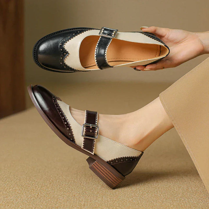 Female model wearing scalloped edge Mary Jane flats on a plain background.