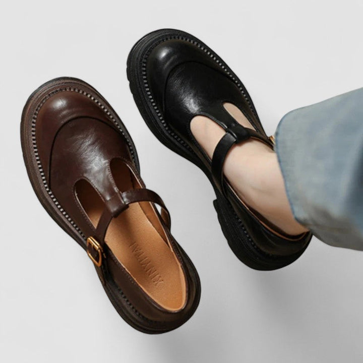 Female wearing everyday Mary Jane shoes with a soft rounded shape on a plain background.