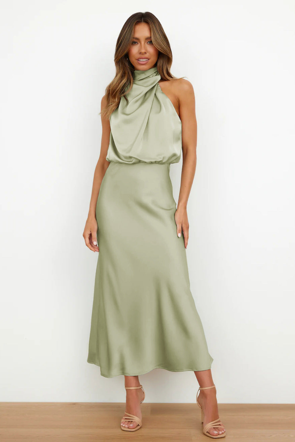 Female wearing a flowing outfit on a plain background with a relaxed and stylish look.