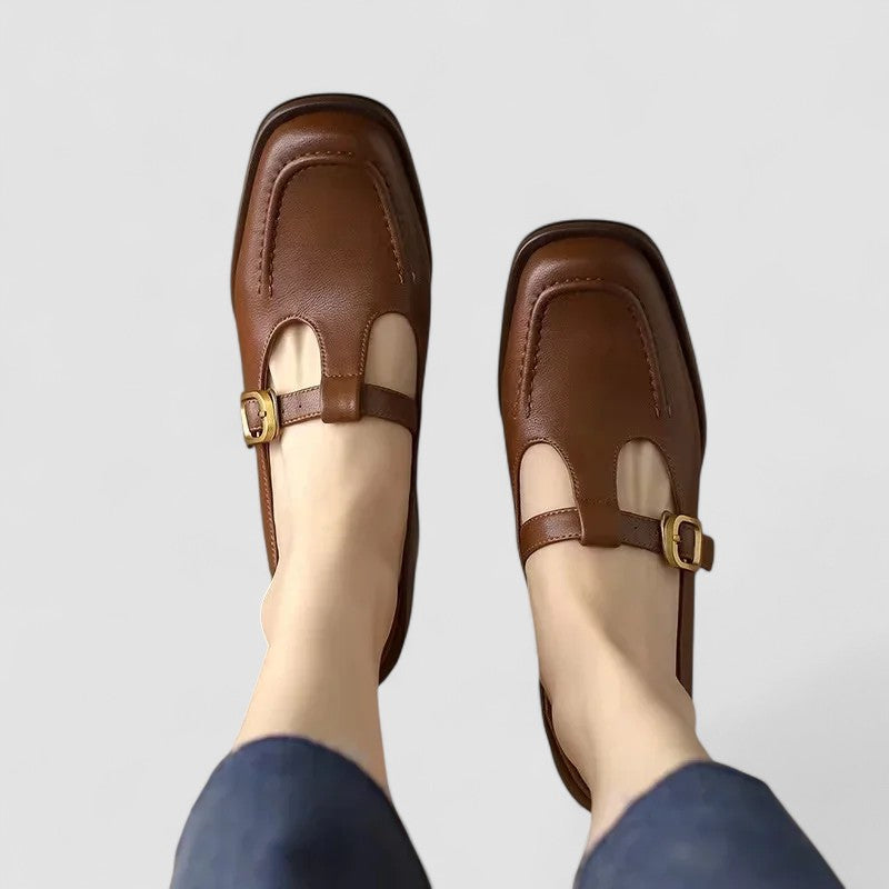 Women’s Mary Jane shoes on a plain background with a classic strap design.