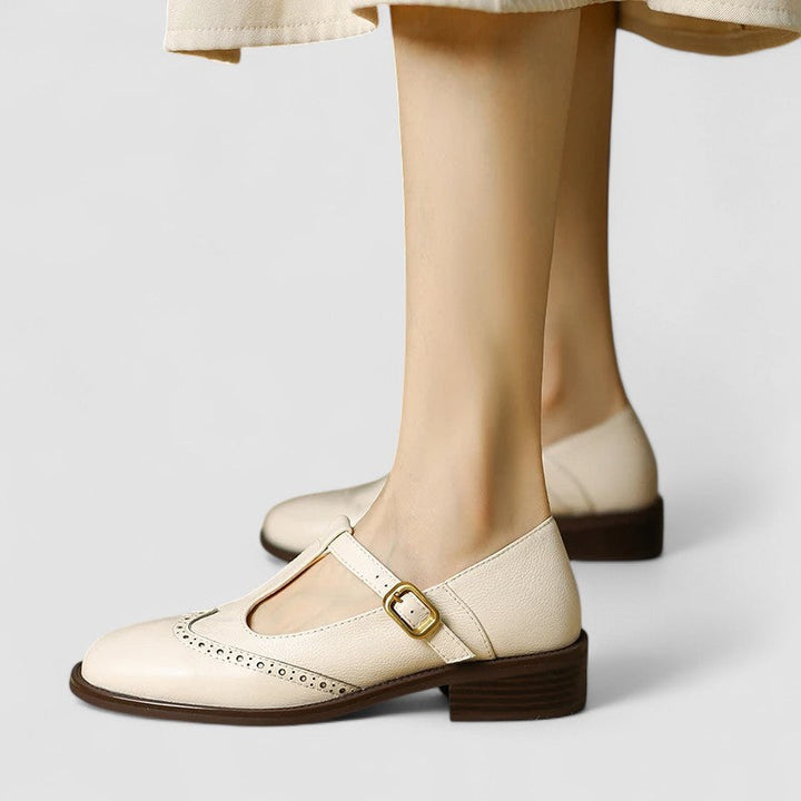 Women’s Mary Jane shoes on a plain background with a rounded toe and simple strap.