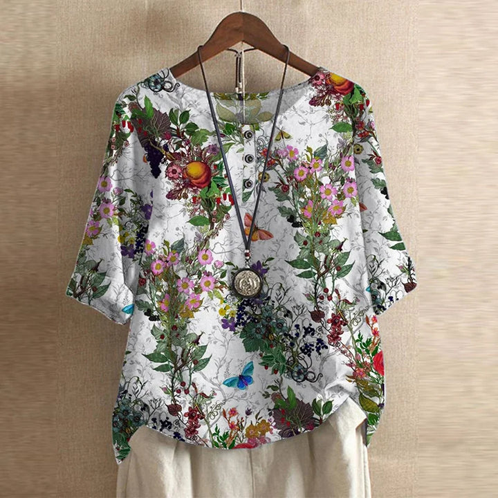 Relaxed floral maxi dress with pleated styling on a plain background.