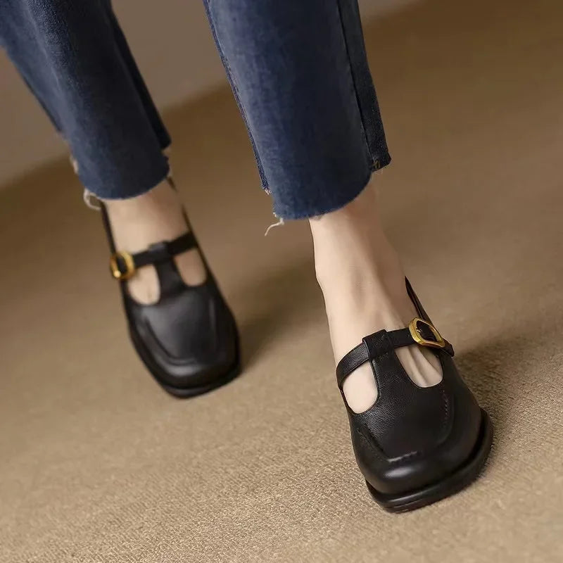 Woman wearing everyday strap shoes with a clean square toe finish.