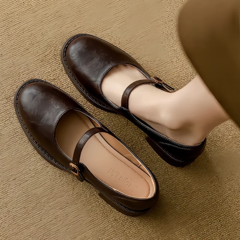 Round toe Mary Jane shoes shown on a plain background in a simple layout.