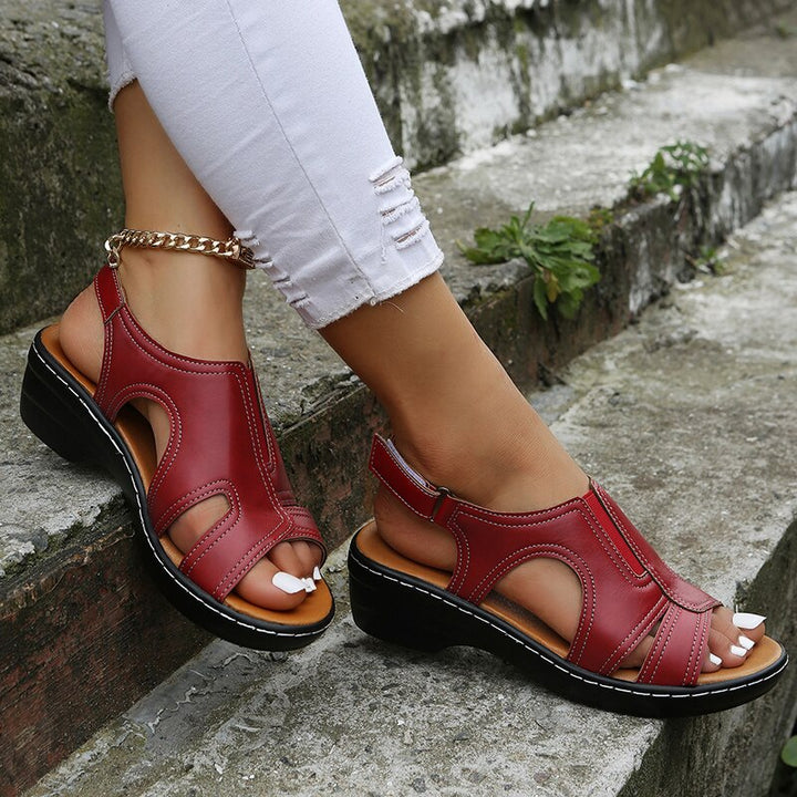 Woman model showcasing casual warm weather sandals on a plain background.