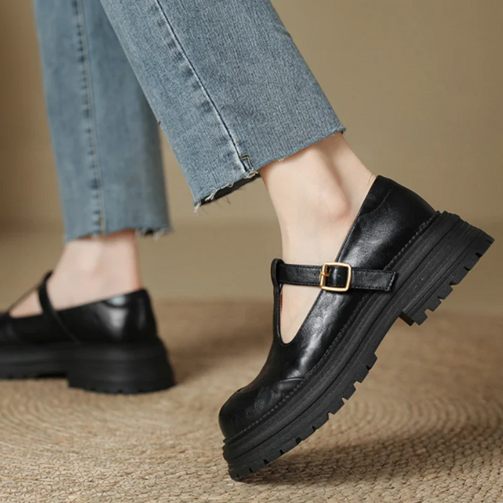 Female dress heels with a clean pointed toe and block heel on a plain background.