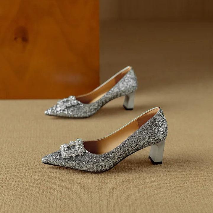 Glitter heels with a refined evening look on a plain background.