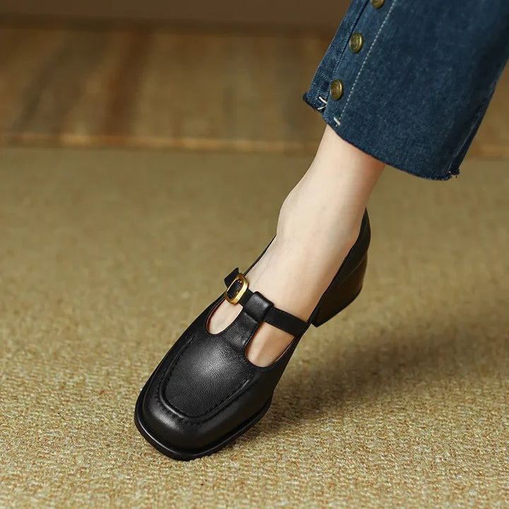 Female model wearing adjustable buckle shoes with a neat structured shape.