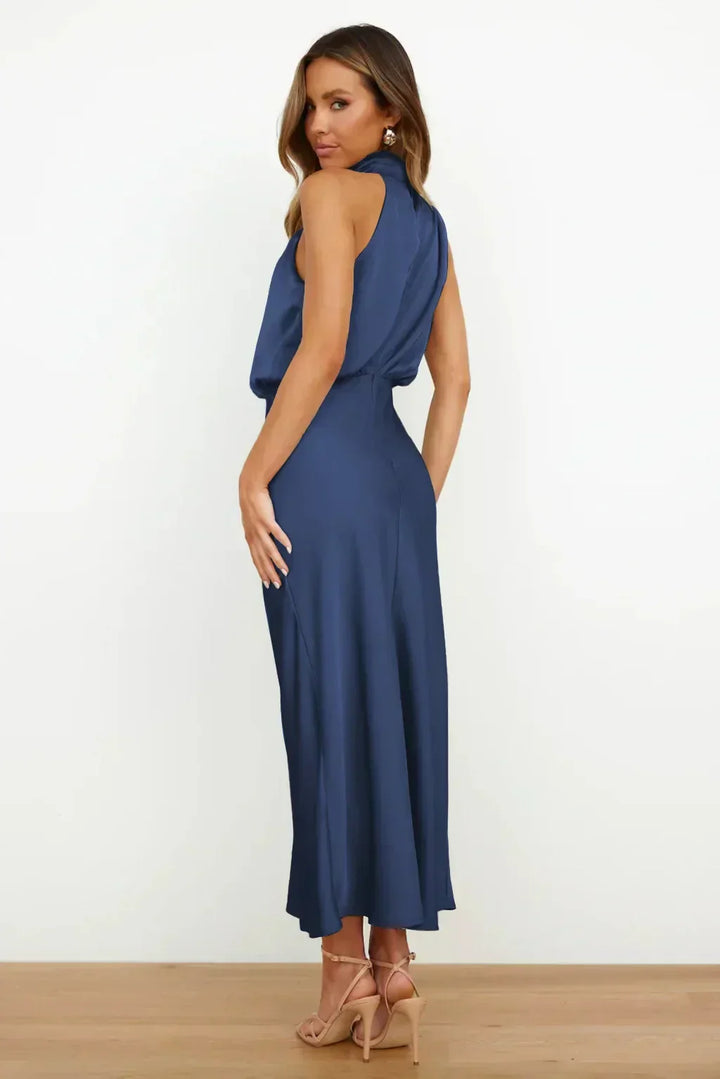 Female showcasing a relaxed silhouette outfit with graceful drape on a plain background.