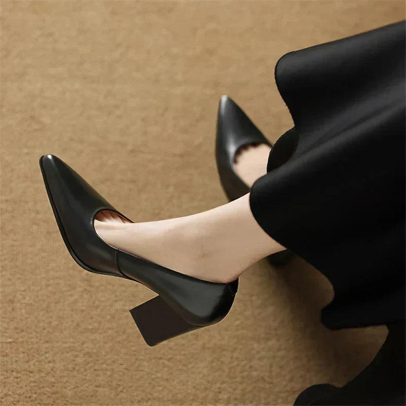 Female model wearing polished tan pumps for smart everyday styling on a plain background.