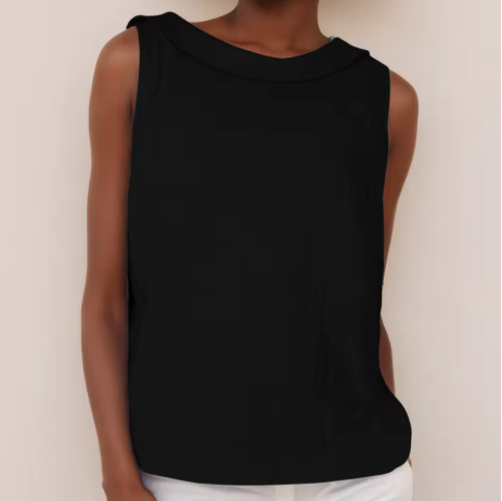  Woman showcasing a sleeveless summer blouse with a refined neckline against a plain background.