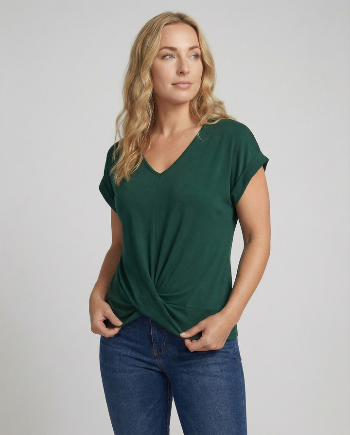 Woman wearing a short sleeve V-neck blouse against a plain background.
