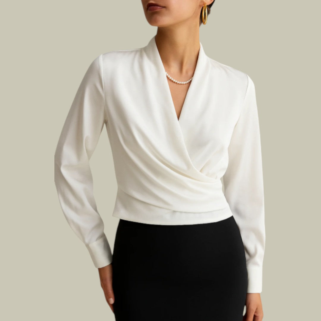 Female model in a wrap inspired blouse styled for everyday outfits on a plain background.