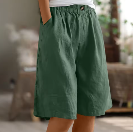 Relaxed summer shorts for women on a plain background.