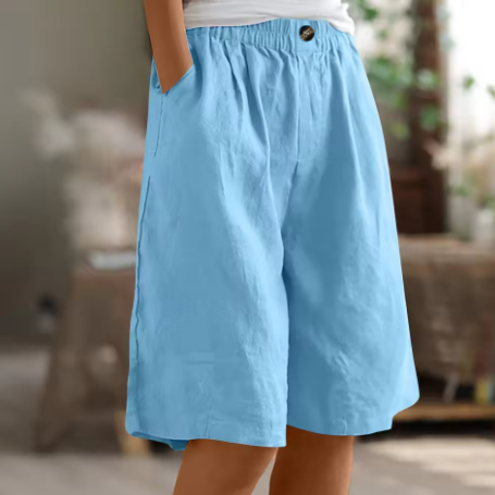 Women’s loose fit shorts for errands and home wear on a plain background.