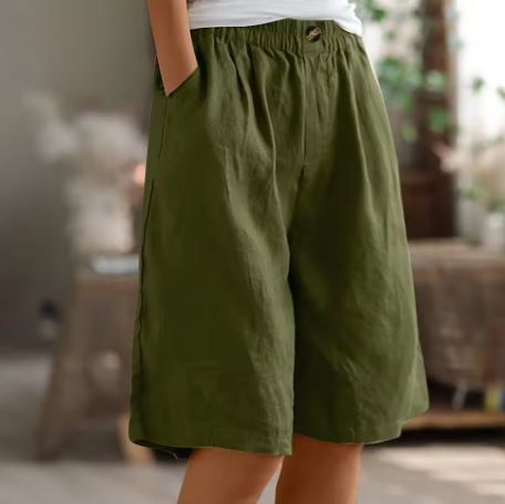 Women’s relaxed mid-length shorts on a plain background.