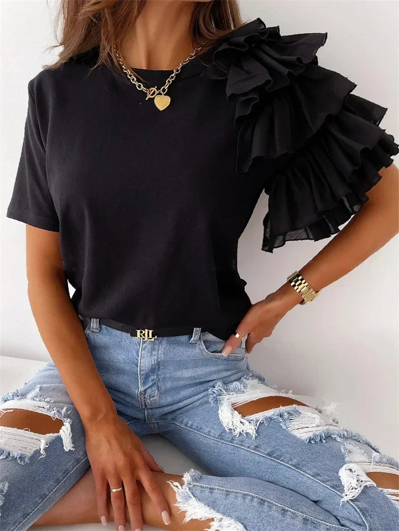  Female modelling a lightweight draped top with soft ruffle sleeve detailing.