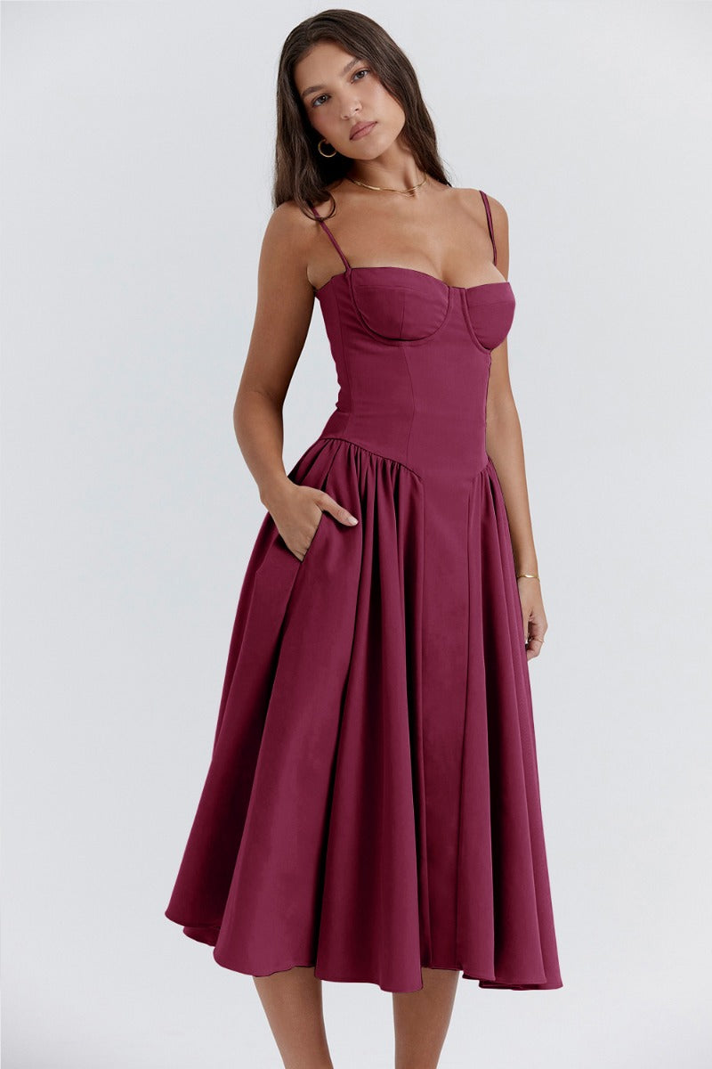Female model showcasing a day-to-night midi dress on a plain background.