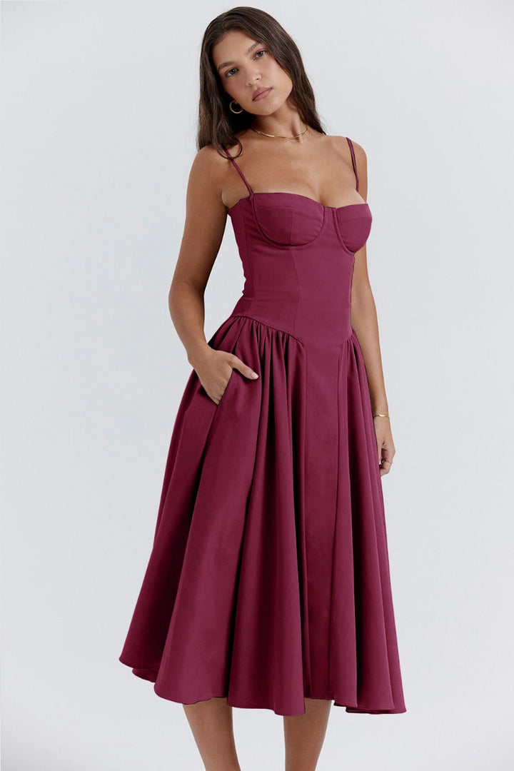 Female model showcasing a day-to-night midi dress on a plain background.