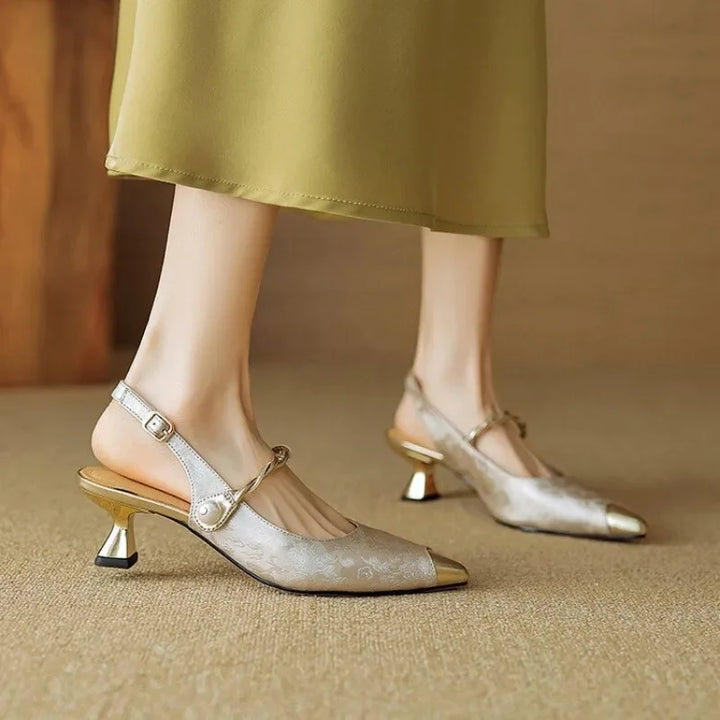 Dressy slingback heel with floral upper and sculpted gold tone heel.