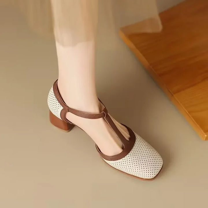 Female model wearing vintage-inspired T-strap heels on a plain background.