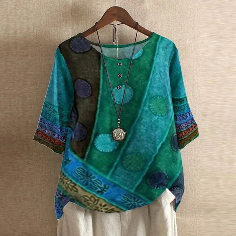 A floral print blouse styled for everyday wear against a plain backdrop.