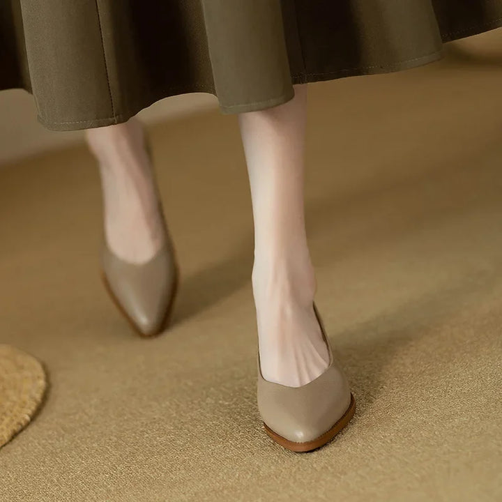 Model wearing refined pointed toe pumps on a plain background.