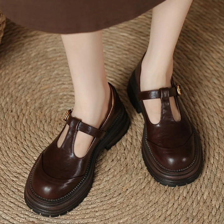Female slip-on pointed toe heels with a mid-height block heel on a plain background.