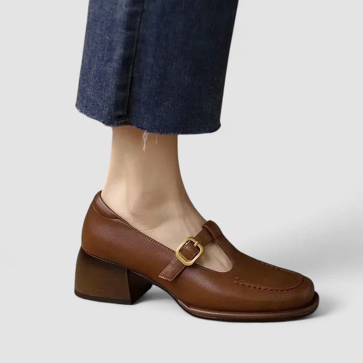 Classic women’s strap shoes displayed on a plain background.