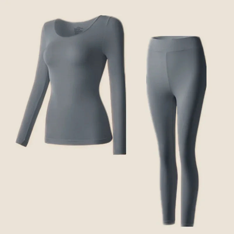 Fitted long sleeve top and thermal leggings on a plain background.