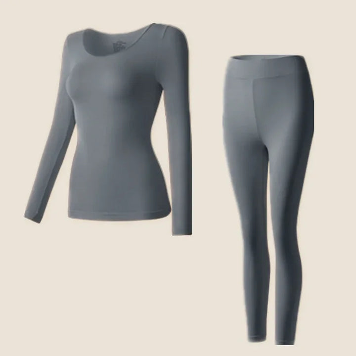 Fitted long sleeve top and thermal leggings on a plain background.