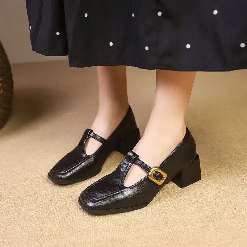 Female model showcasing vintage inspired Mary Jane heels on a plain background.