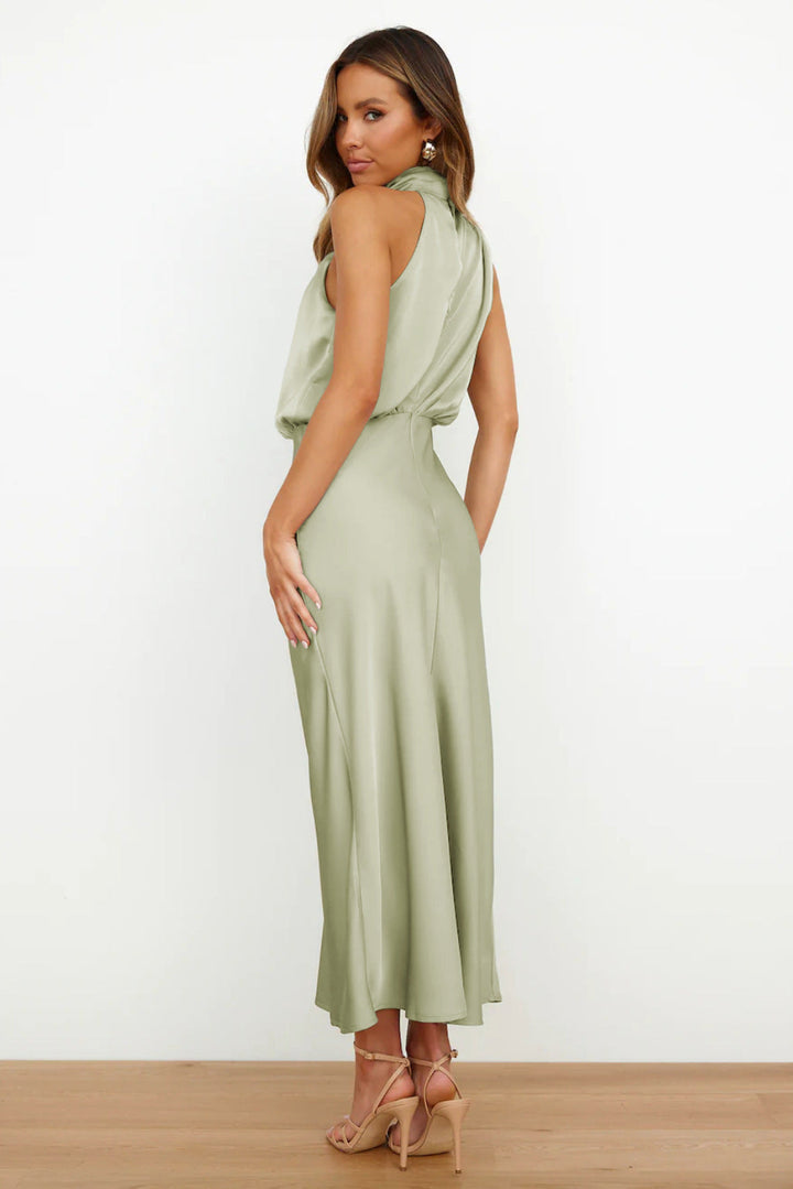 Woman posing in a graceful casual outfit against a plain background.