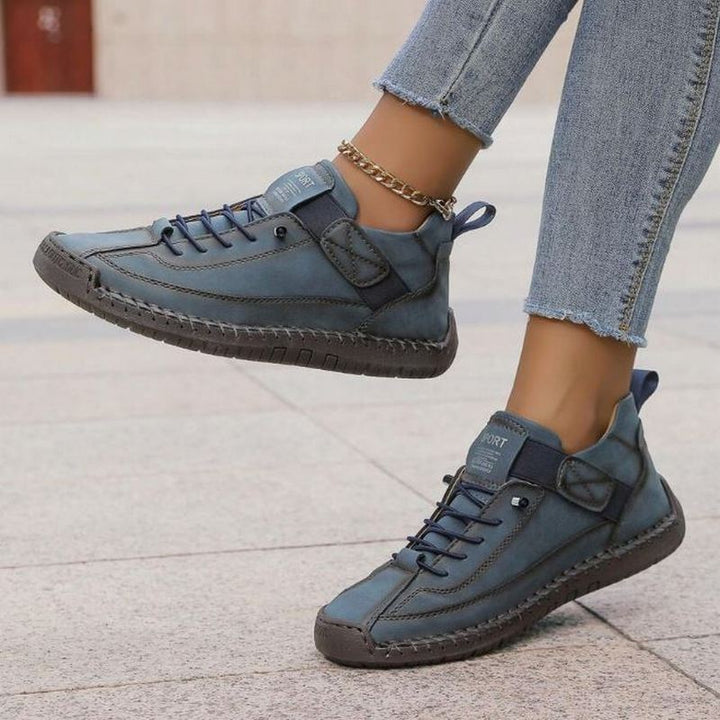  Female model displaying casual footwear with a comfortable cushioned interior on a plain background.