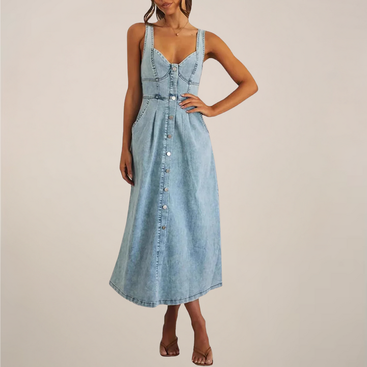 Female model in a sleeveless midi dress with a fitted waist and flowing skirt on a plain background.