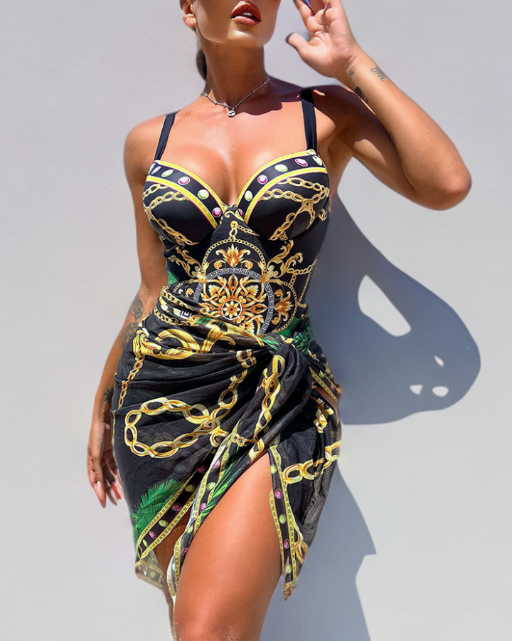 Female model wearing a stylish swimsuit with matching skirt on a plain background.