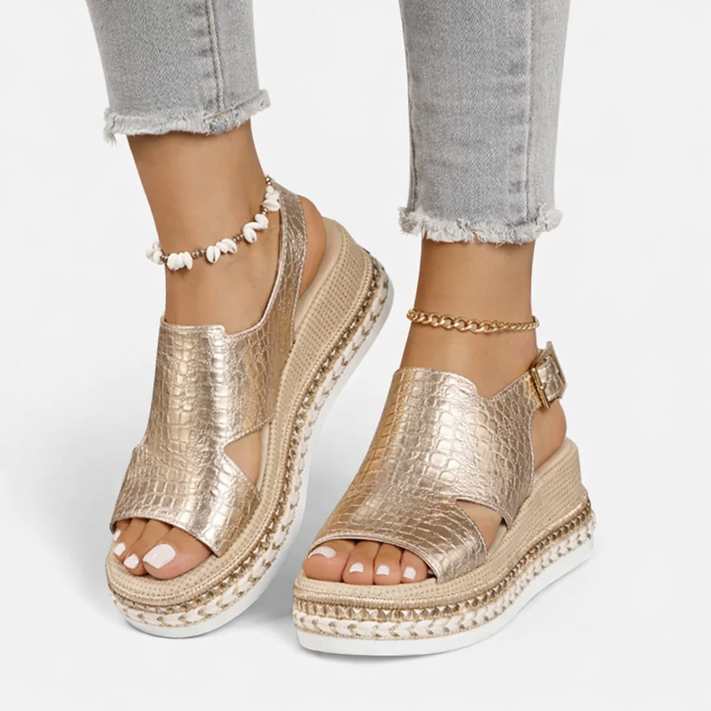 Woman in croc-style wedge sandals shown on a plain background for a clean summer footwear look.