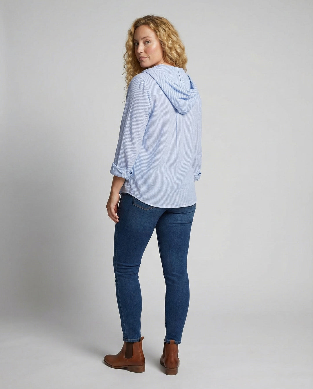 Woman in a classic lightweight blouse on a plain background.