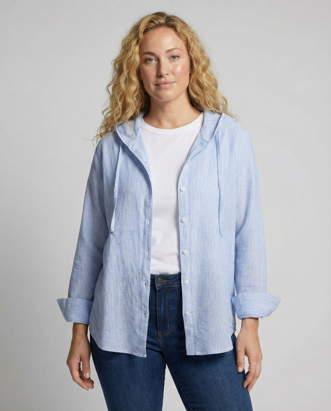 Woman wearing a lightweight blouse against a plain background.