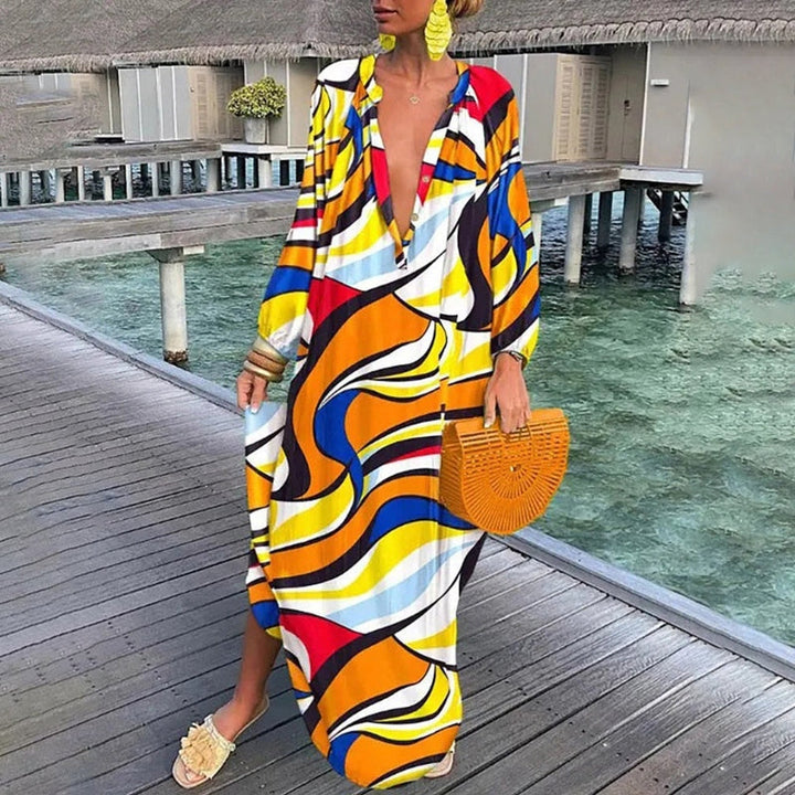 Woman in a loose fit abstract print dress on a beach background.