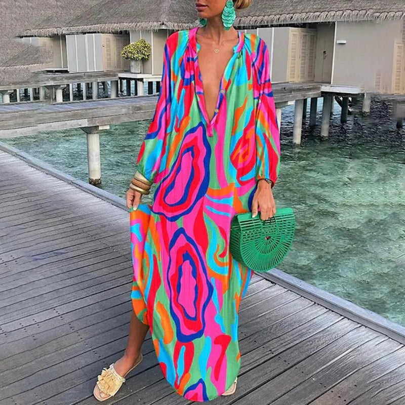 Woman wearing a casual abstract dress with relaxed drape on a beach background.